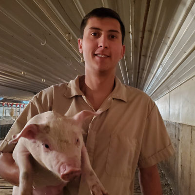 Dylan Majerus holding pig