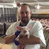 Sean Scroggin holding piglet